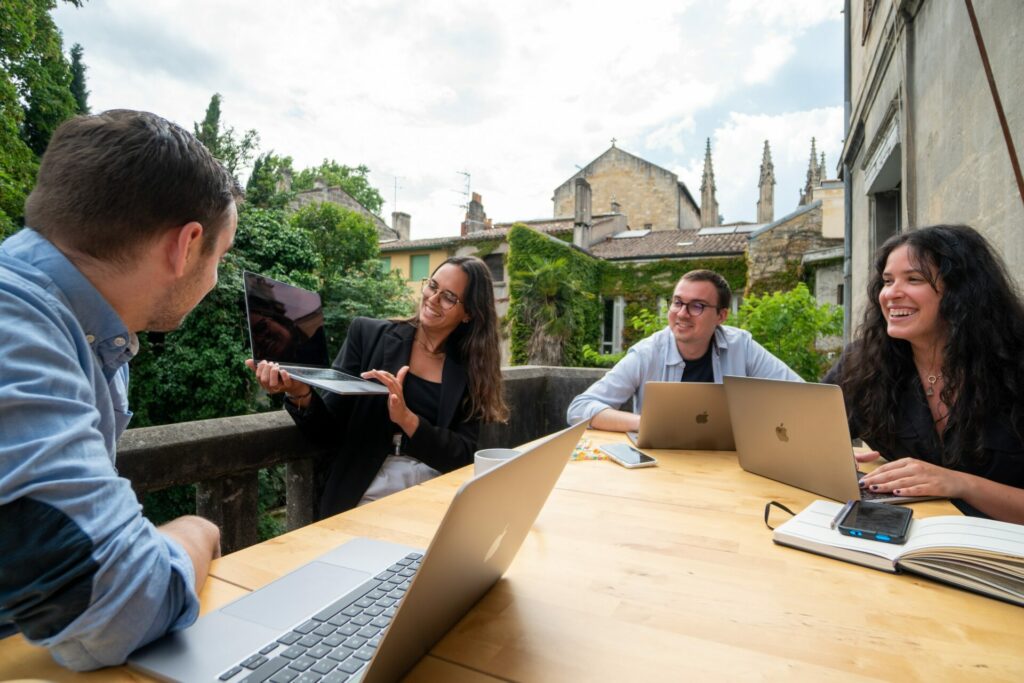 group of young people looking at a computer